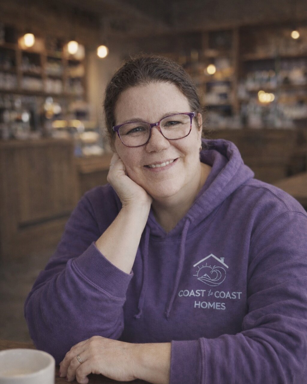Judy Lea working at a table with a coffee