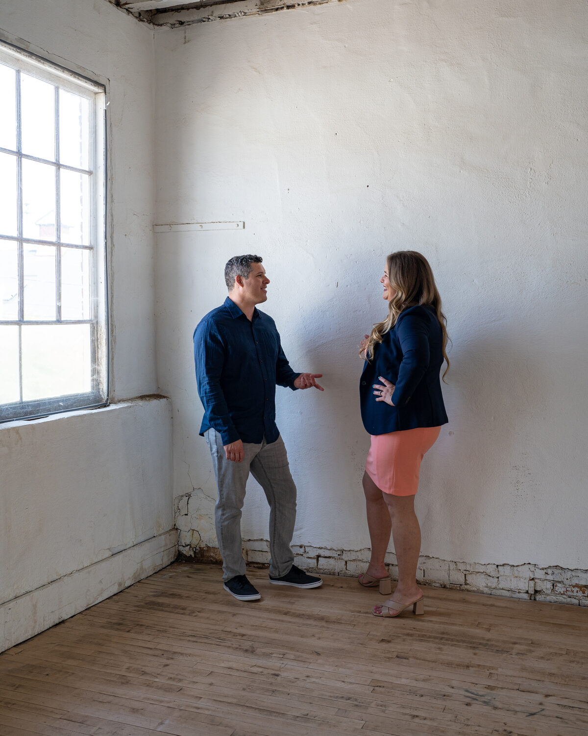 Colin and Nicole talking through a project in an empty unit